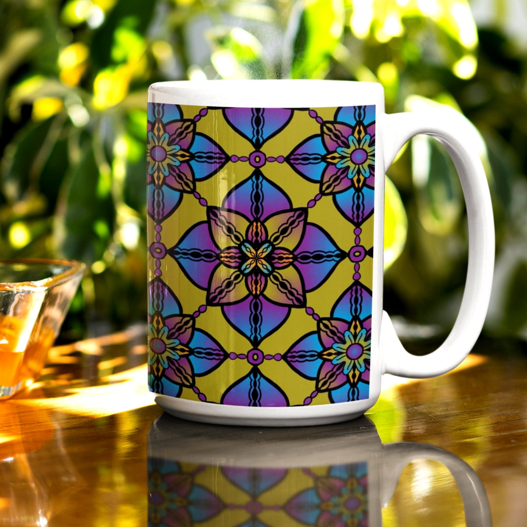 A kaleidoscope mandala mug in purple, blue, and yellow hues