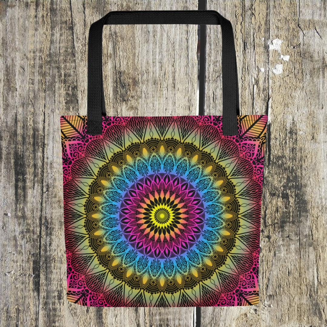  A lively mandala tote bag named 'Color Burst: Vibrant Mandala' in Pink, Blue, and Yellow, exuding energy and artistic expression.